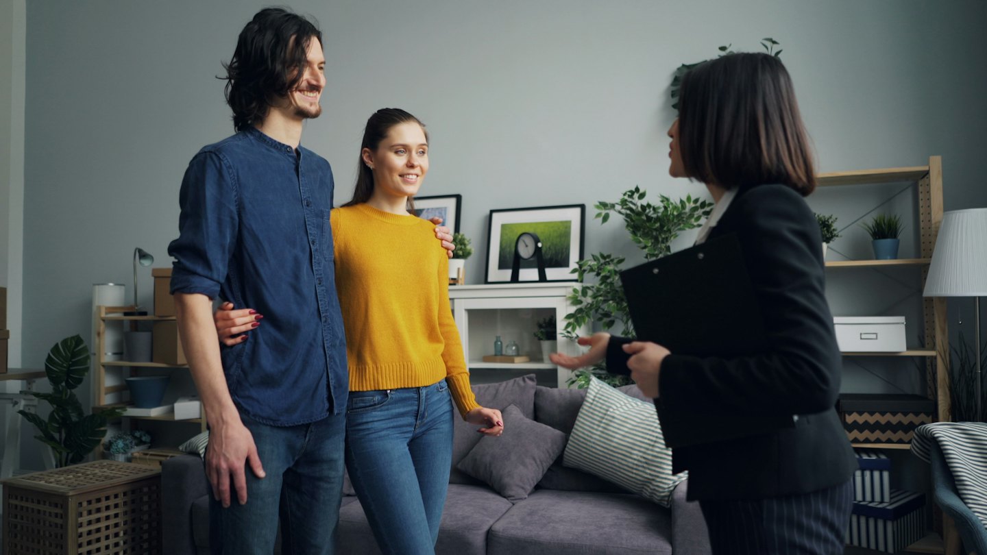 Real estate agent shows a couple a new home.